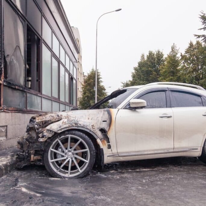 white-car-burnt-building